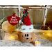 This image shows a Christmas Elf Decoration. It is made using a dried gourd. The elf is named Zingle Kringle and is wearing a handmade hat. 